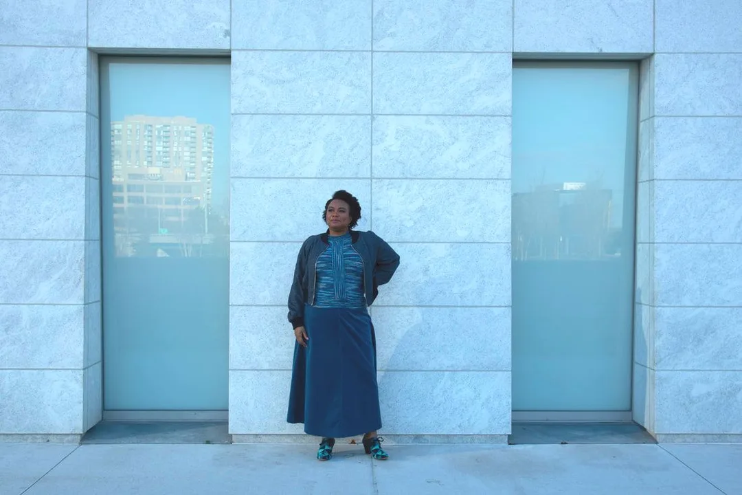 Model, Kejo, is wearing the Hand Knit Top in Arctic Ocean and the Full Corduroy Skirt in Lake Louise from the current collection. The Navy Lined Flight Jacket, pictured, is from a previous collection.